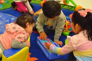 Three children playing in a daycare setting