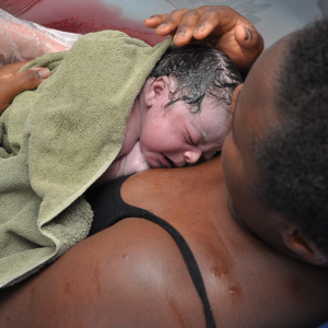 Black parent holds newborn